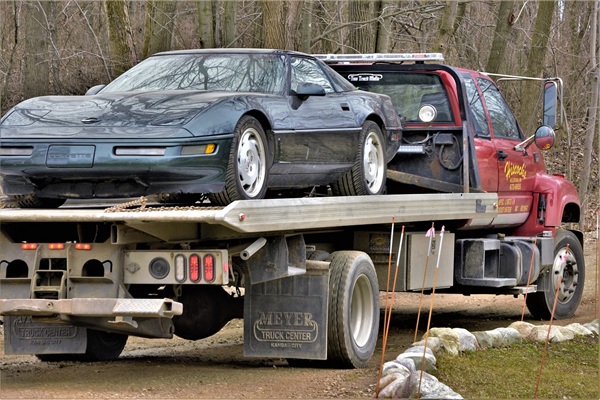 Virginia Car Shipping Services 2 Virginia car shipping hauler with cars loaded on an open trailer driving down the road Car hauler loaded with vehicles providing Virginia car shipping service